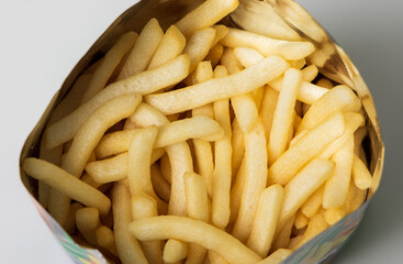 Crispy french fries shape in bag package. Fast food or junk food snacks unhealthy concept.