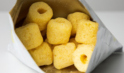 Crispy Corn rings salty snacks in bag package. Fast food or junk food snacks unhealthy concept.