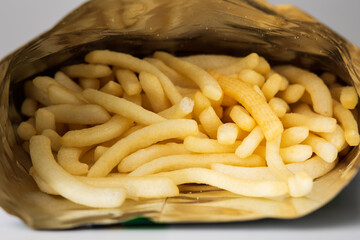 Crispy french fries shape in bag package. Fast food or junk food snacks unhealthy concept.