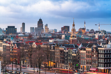 Amsterdam, Netherlands historic cityscape with the modern Zuidas district in the distance