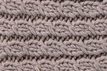 grey textured background with a pattern pigtail.