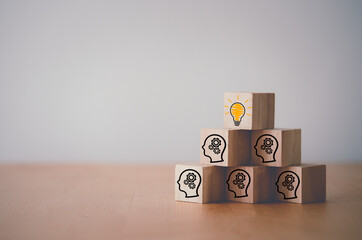 Wooden cube block which print screen lightbulb icon on face with gear, creative idea and innovation...