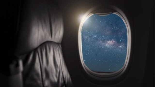 Time lapse, Window View From Passenger Seat On Commercial Airplane with milky way, Concept of travel and air transportation, Concept of travel and air transportation.