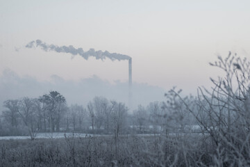  Smoking chimneys on the winter sky background. Heating season. Coal processing plant. smoke of pipes pollutes atmosp.here of the city. pollution of environment, emissions into water resources