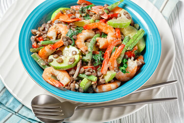 Salad of lentils, shrimps, wilted kale on a plate