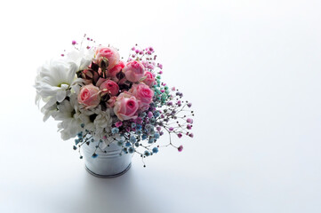White roses and chrysanthemums on a white background. Bride's bouquet. background. Soft pastel colors. Background for postcards, invitations, and greetings.