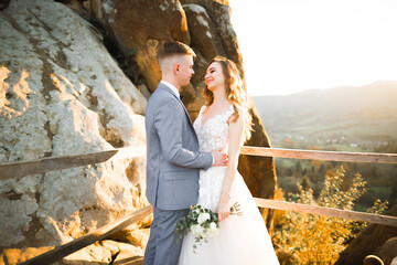 Gorgeous happy couple standing close to each other and looking in eyes