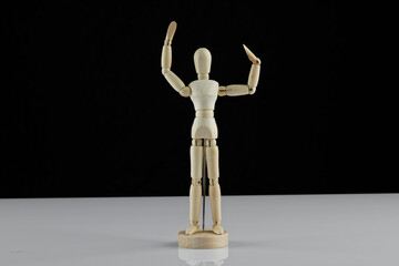 wooden human model poses on the table