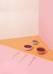 Plates with beetroot soup, borscht on yellow table, abstract composition. Conceptual art, healthy still life, copy space