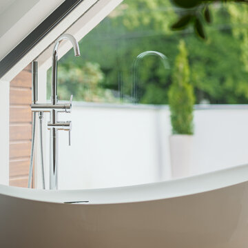 Close-up on silver tap in bathtub