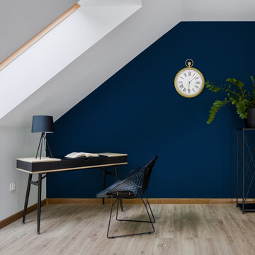Attic home office room with dark blue wall
