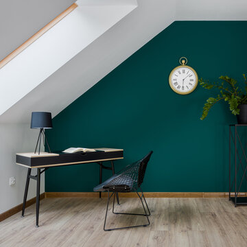 Attic home office room with emerald green wall