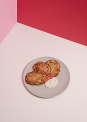 Plate with vegetable cheesecakes, abstract composition. Conceptual art, still life, copy space