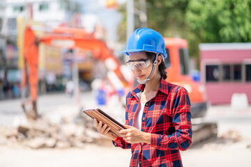 A female engineer is inspecting work at the construction site.
