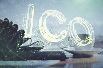 Double exposure of crypto technology drawing and desktop with coffee and items on table background....