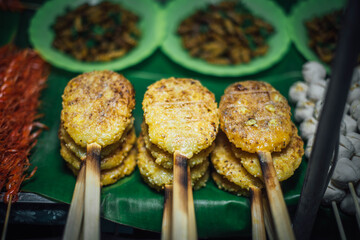Sticky rice skewered with grilled eggs for sale on Walking Street, Chiang Khan District, Thailand