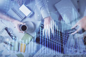 Double exposure of man and woman working together and forex graph hologram drawing. Financial analysis concept. Computer background. Top View.