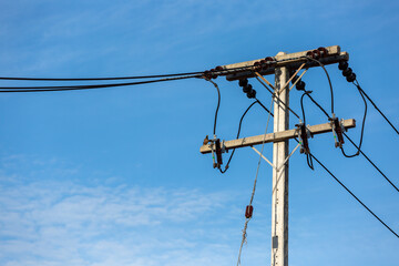 Electric Pole Power Lines And Wires With Blue Sky Background