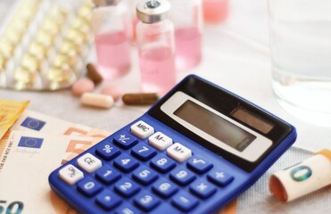 calculator, medicines and euro bills