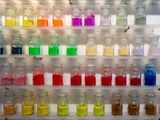 Row of colorful dry powder in glass bottle