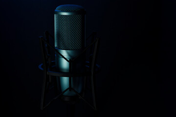 Blue professional microphone isolated on black