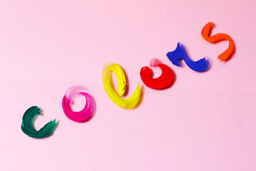 word colors wrote with paints on pink background