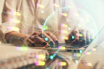 Double exposure of woman hands working on computer and world map hologram drawing. International technology business concept.