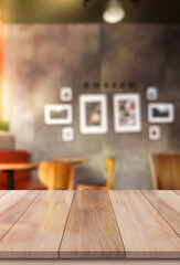 Empty wooden table top with lights bokeh on blur restaurant background.