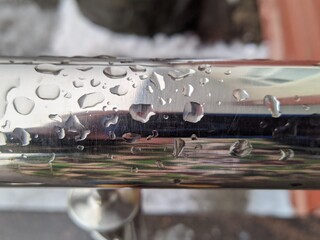 water droplets on the metal rail closeup photo