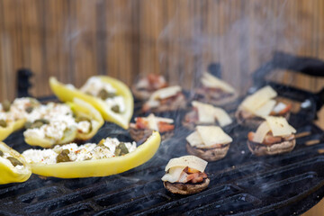grilled peppers with feta cheese and capers and mushrooms with bacon baked with Emmental cheese