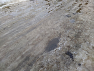 melted snow on a broken and destroyed road