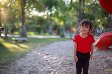 Asian child playing with sand in the playground