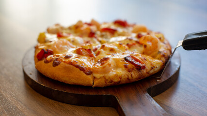 Seafood Italian Pizza slice on wood dish