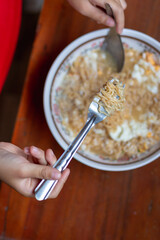 Close up of kid hand eating pasta for lunch.