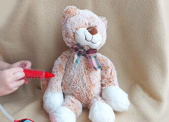 vaccination syringe toy cat. child play in the hospital. injection, treatment, doctor, vaccine.