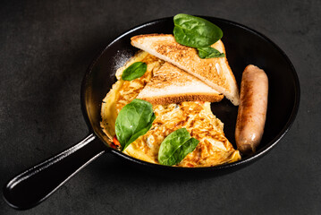 omelet with toasts and sausage