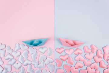 Pink and blue origami paper ships with hearts. Loves and family concept. Valentines day greetings card. Flat lay. Copy space.