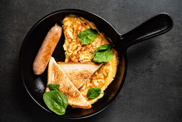 omelet with toasts and sausage