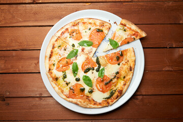Pizza with cheese tomatoes and pesto sauce