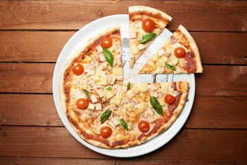 italian pizza with tomato chees and chicken on the plate