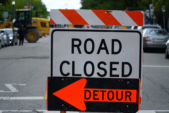 Horizontal Shot Of 'Road Closed' Barrier With Detour Sign   