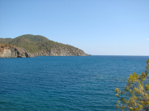 Unsurpassed natural picture of the azure surface of the calm sea on a background of clear blue sky.