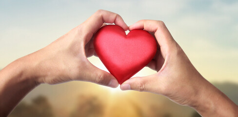 Fototapeta na wymiar Hands holding red heart. heart health donation concepts