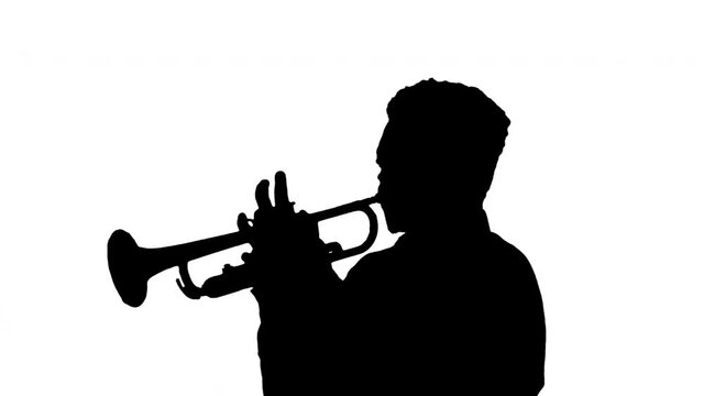 Silhouette African american musician playing the trumpet expressively.