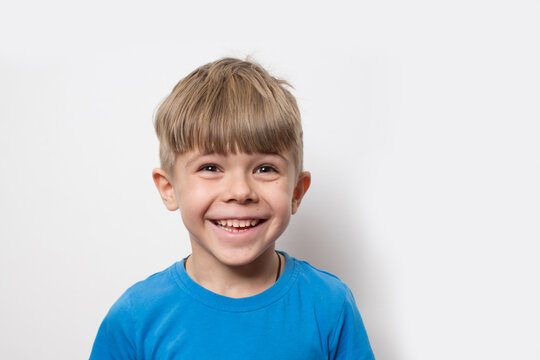 Portrait of cute little boy wearing blue t shirt isolated over white background