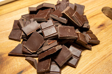 Chocolate pieces on a wooden background, cooking ingredient concept