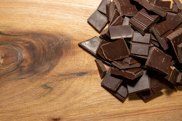 Chocolate pieces on a wooden background, cooking ingredient concept