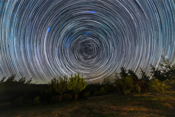 The Earth rotation as seen in the night sky with the star trails. An awe scenery in the outdoors...