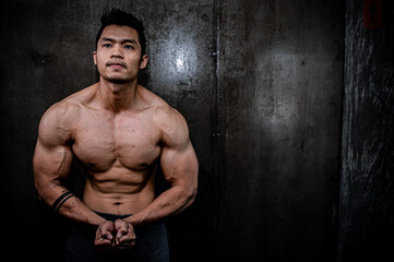 Fototapeta premium Portrait of asian man big muscle at the gym,Thailand people,Workout for good healthy,Body weight training,Fitness at the gym concept
