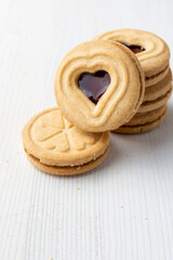 Top view of heart-shaped cookies on white table, vertically, with copy space